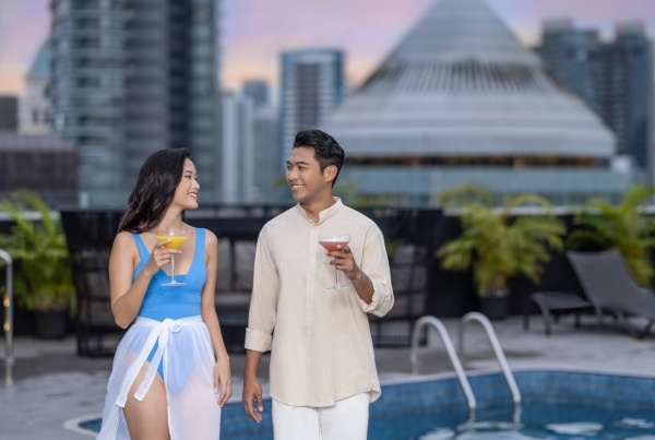 Young couple at poolside of voco hotel singapore - lifestyle commercial photography