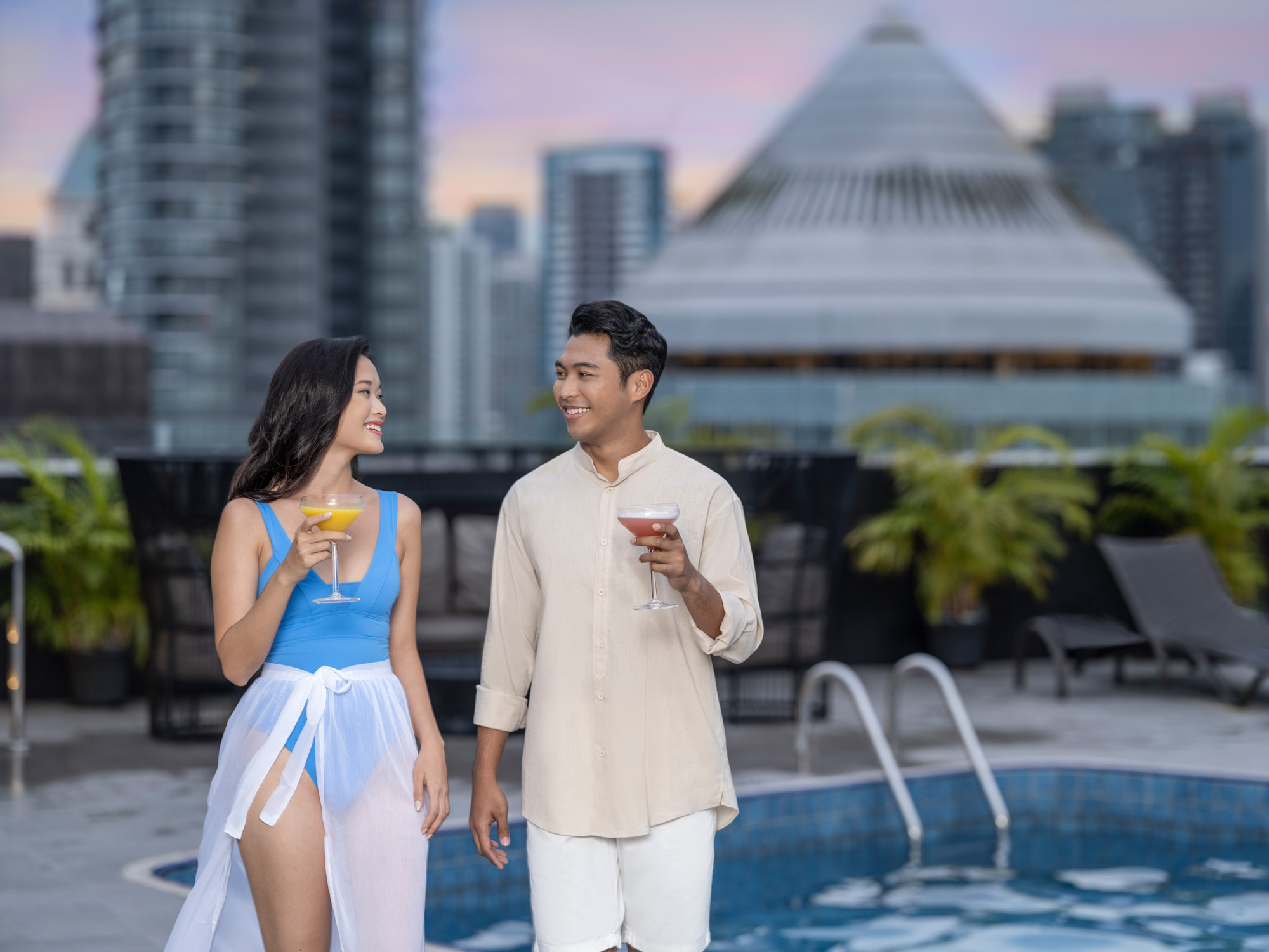 Young couple at poolside of voco hotel singapore - lifestyle commercial photography