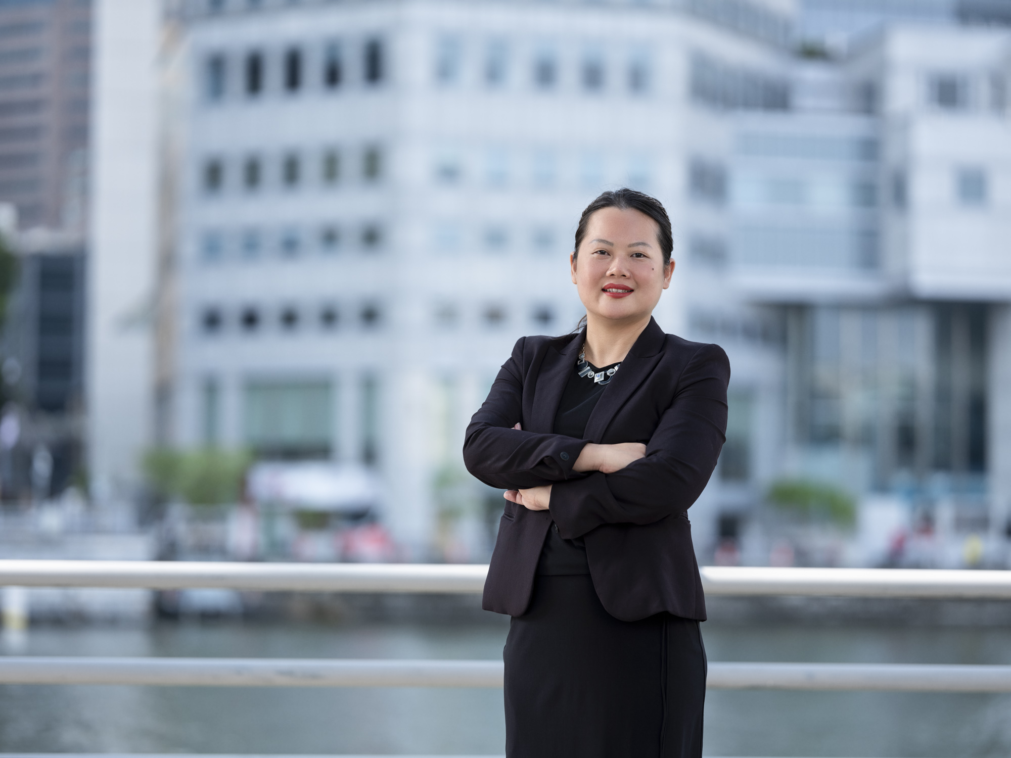 businesswoman in front of singapore river taking a corporate headshot