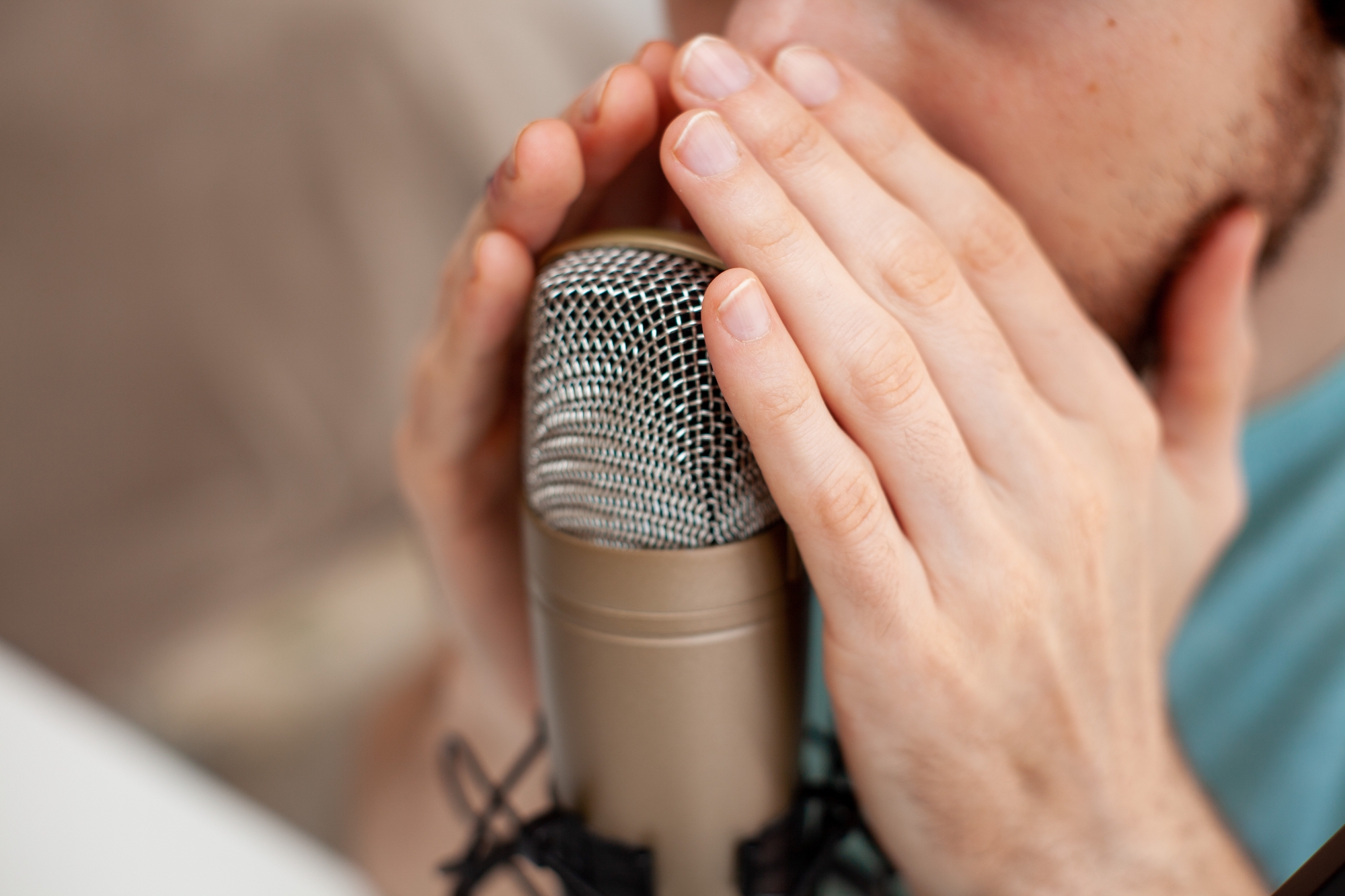 man whispering into microphone for asmr marketing videos
