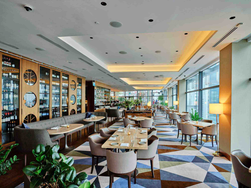 Artemis Restaurant Interior Photo with the tables, sofas and wine cabinet view