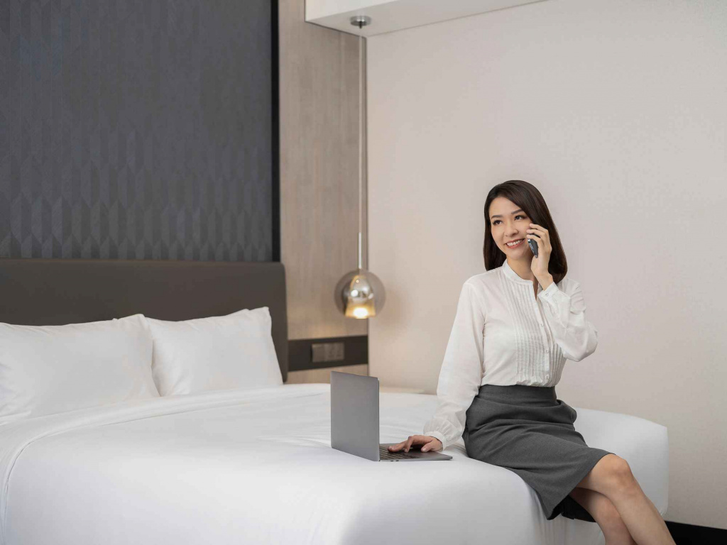 Lady working in bed in orchid hotel, photo taken by coco creative studio lifestyle shoot-Orchid-lifestyle-interior-hospitality-photgraphy-coco-creative-studio-singapore-france