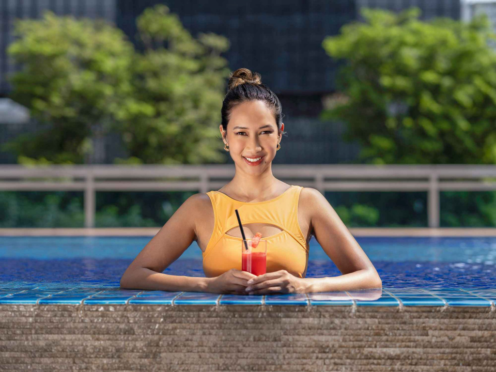 Lady enjoying watermelon juice in the pool in orchid hotel, photo taken by coco creative studio lifestyle shoot-Orchid-lifestyle-interior-hospitality-photgraphy-coco-creative-studio-singapore-france