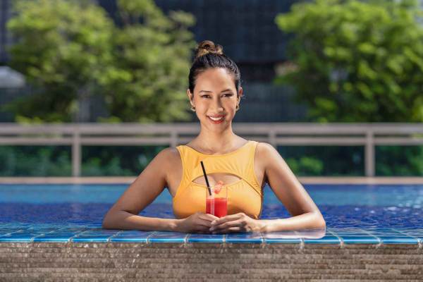 Lady enjoying watermelon juice in the pool in orchid hotel, photo taken by coco creative studio lifestyle shoot-Orchid-lifestyle-interior-hospitality-photgraphy-coco-creative-studio-singapore-france