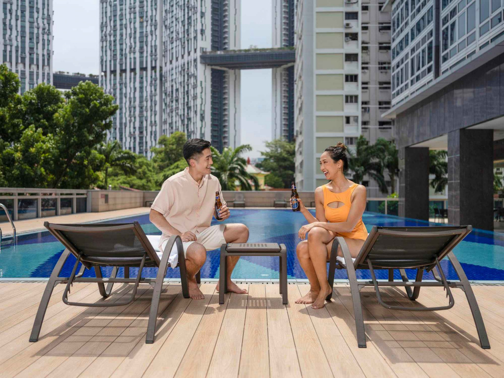 A couple enjoying beers at the pool side, photo taken by coco creative studio lifestyle shoot Orchid-lifestyle-interior-hospitality-photgraphy-coco-creative-studio-singapore-france