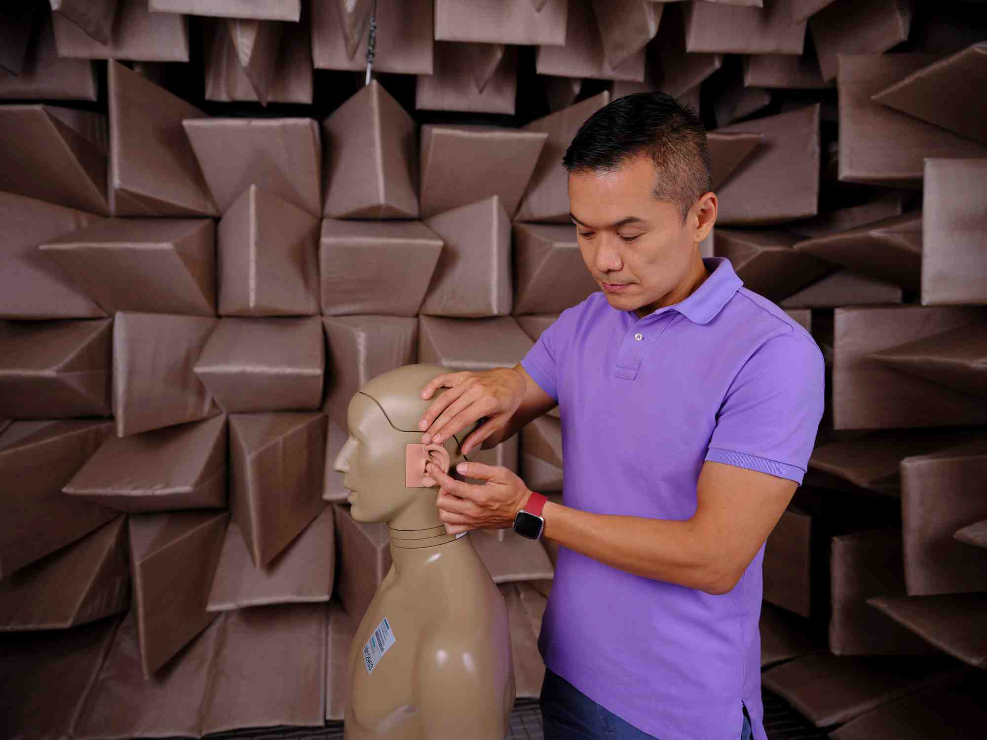 WSA staff testing audio on doll, photo taken by coco creative studio commercial photography