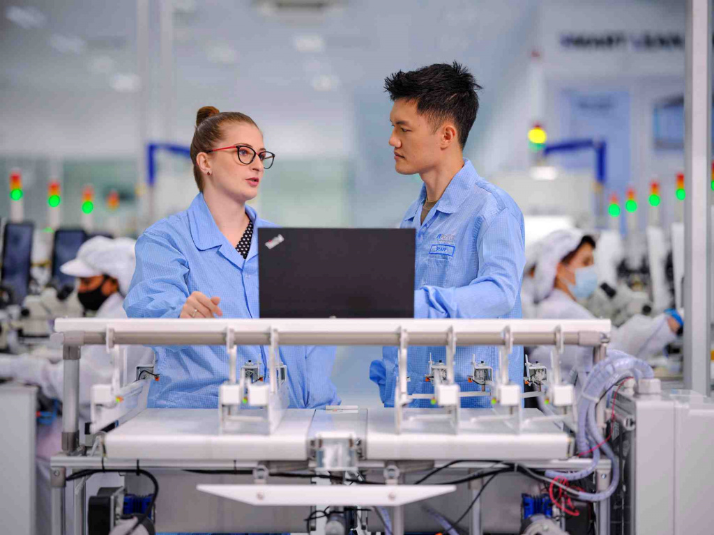 2 WSA staff talking in front industrial machinery, photo taken by coco creative studio commercial photography