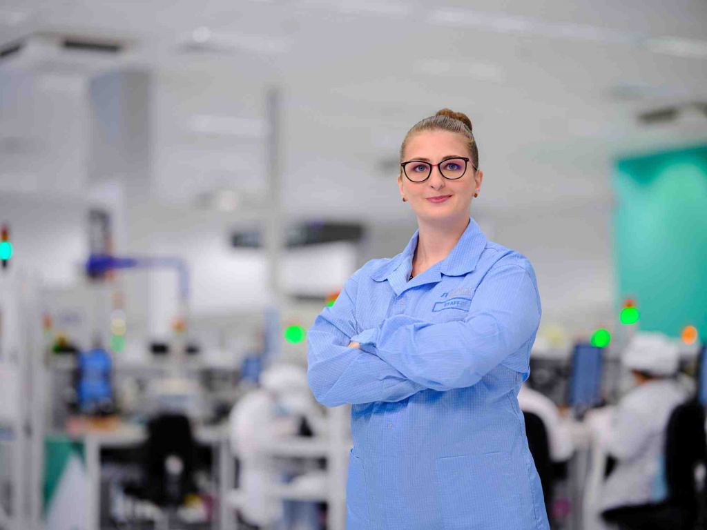 WSA staff standing with crossed arms in front of industrial machines, photo taken by coco creative studio commercial photography