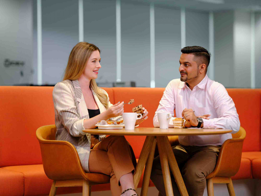 2 WSA colleagues seating at the side table, near the orange sofas, photo taken by coco creative studio commercial photography
