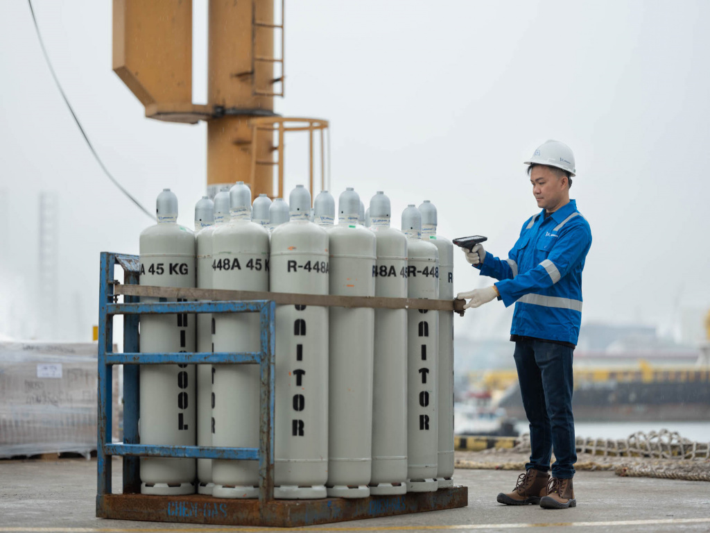 Wihelmson Industrial Photography - guy checking on tanks at a harbour