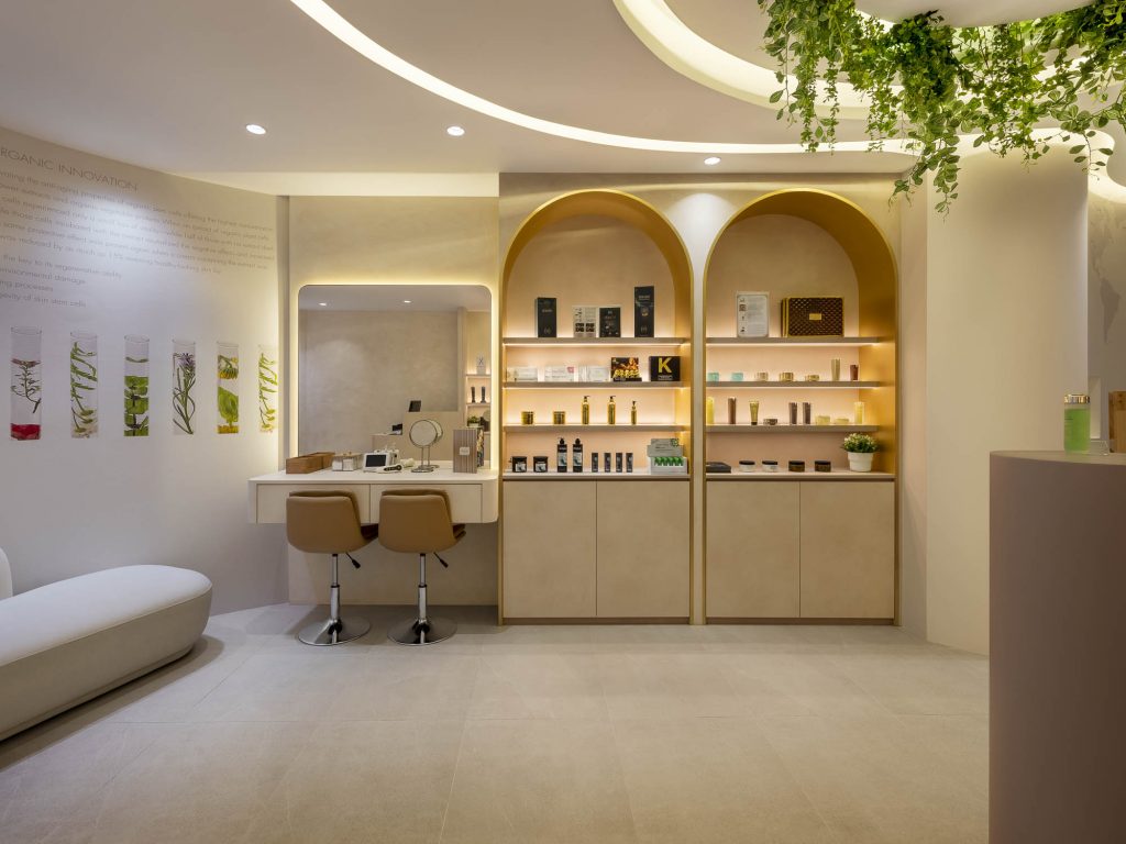 photos of Adore's cosmetics boutique in Singapore. Several products can be seen, as well as a place to sit and have your make-up done.