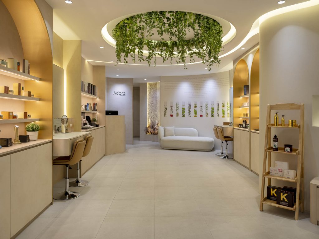 photos of Adore's cosmetics boutique in Singapore. Several products can be seen, as well as a place to sit and have your make-up done.