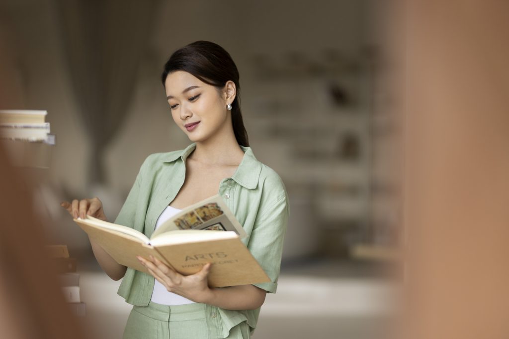 Hotel resort lifestyle photographer Hilton China Asia commercial - Hotel library. Client reading a book