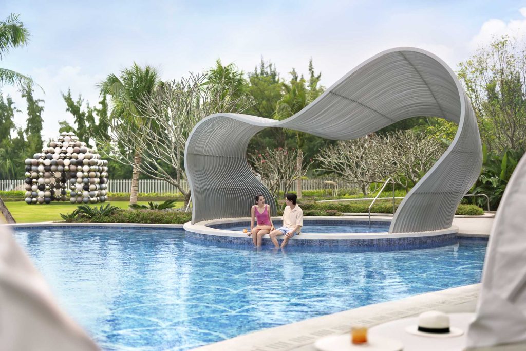 Hotel resort lifestyle photographer Hilton China Asia commercial - A couple sits near the pool