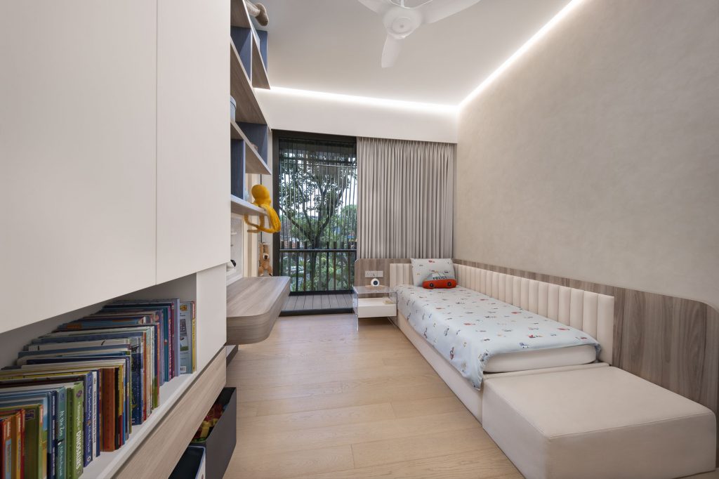 Interior photo of a children's bedroom with a single bed, books, a large window and parquet flooring.