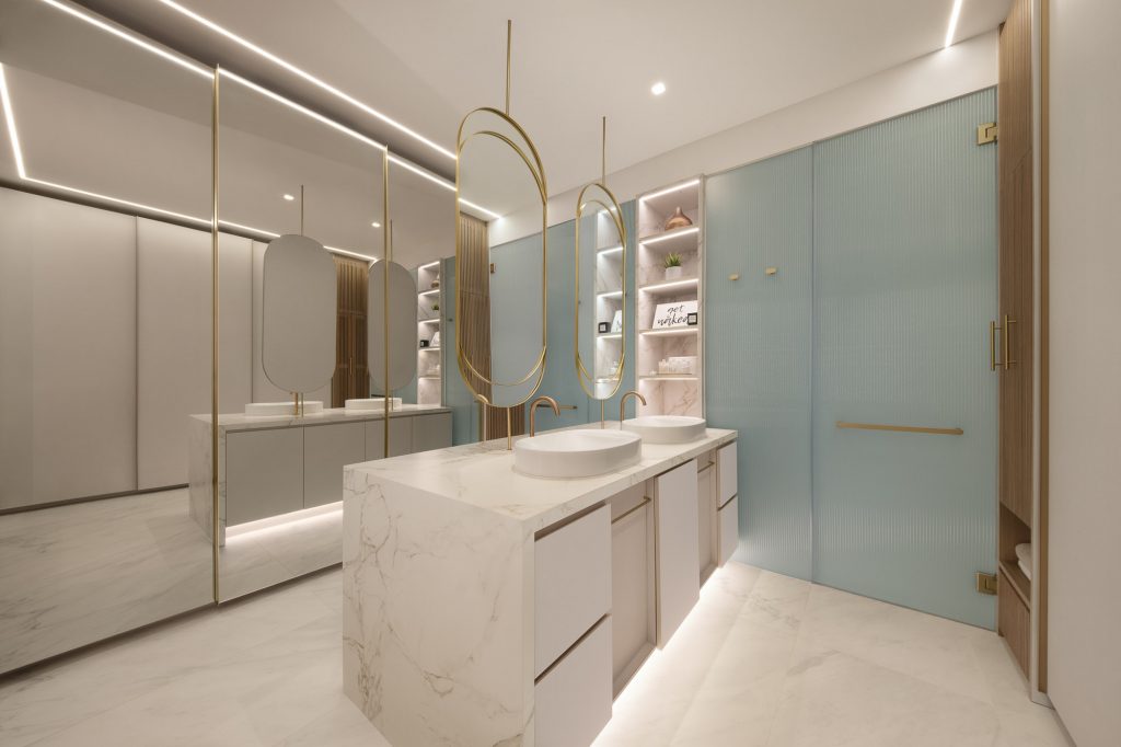 Interior photo of a bathroom with large mirrors, double washbasin and cupboards