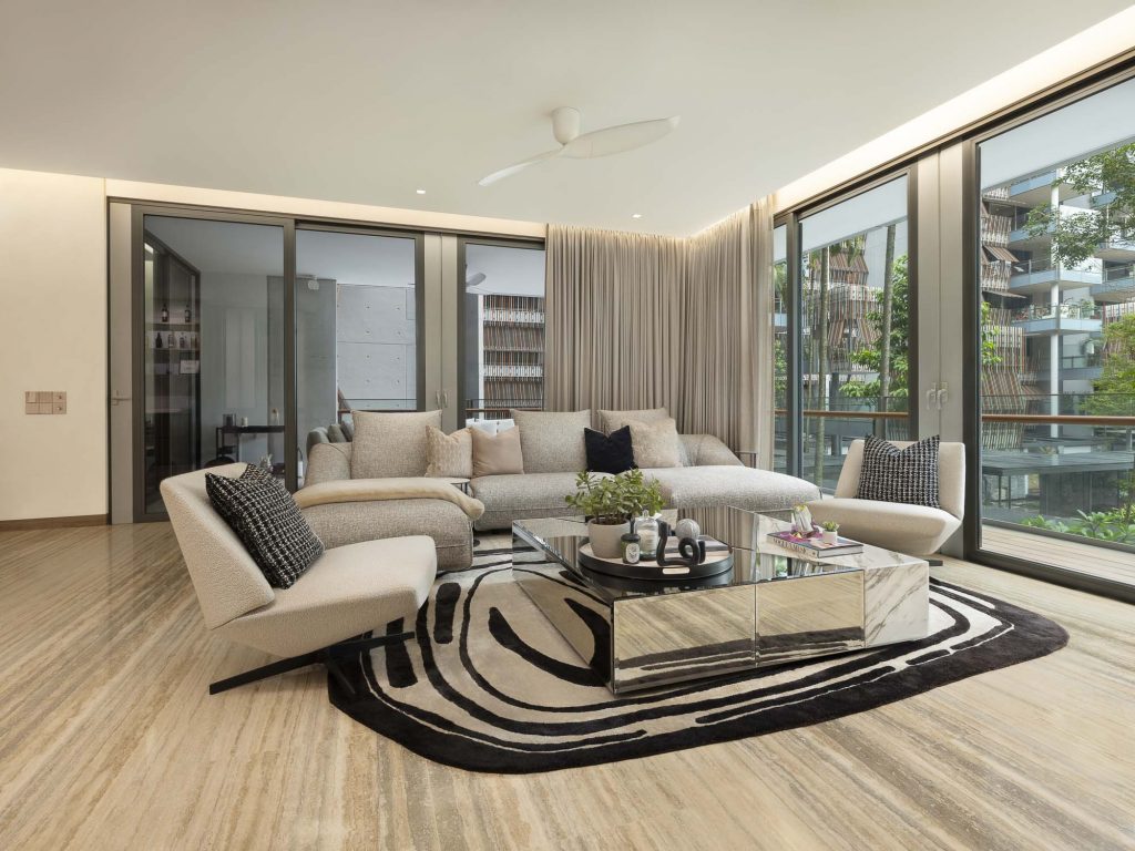 Interior photo of a large living room with sofas, armchairs and large windows