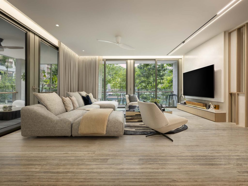 Interior photo of a large living room with sofas, armchairs and large windows