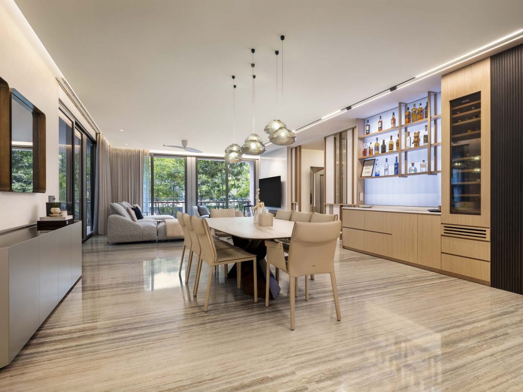 Interior photo of a dining room with a large table and the living room in the background
