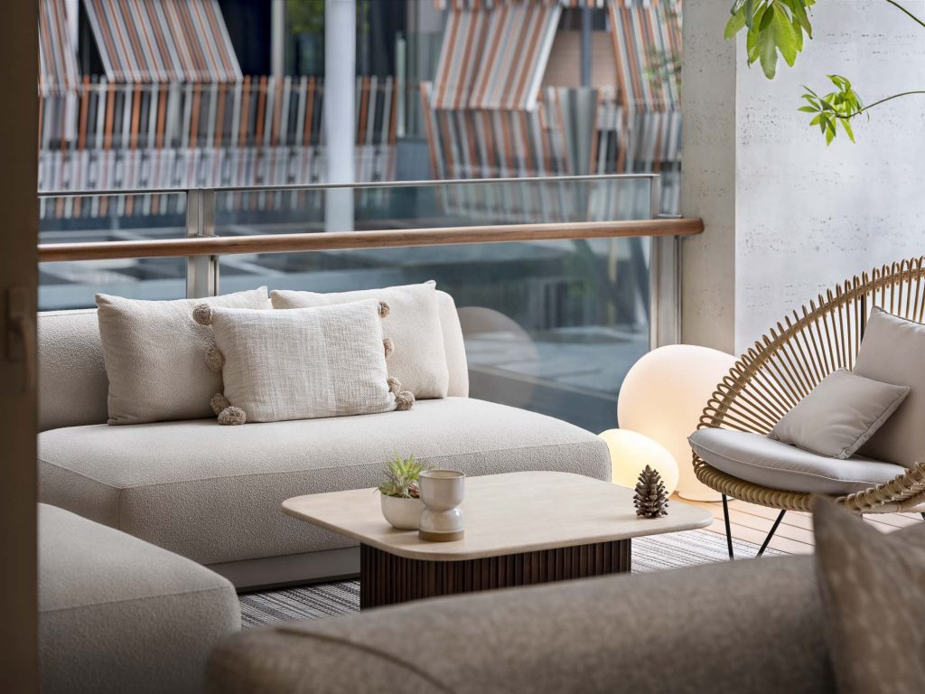 Interior photo of a large living room with sofas, armchairs and large windows