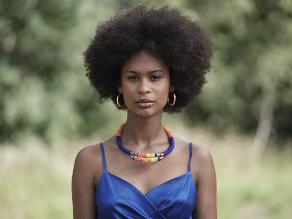 photo portrait in brittany in the fields. The model is wearing a blue dress